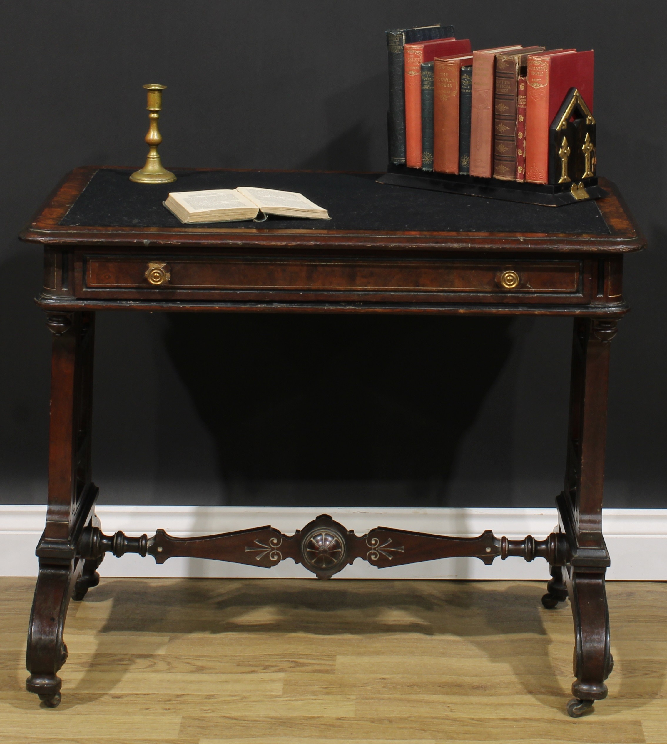 A late Victorian Aesthetic Movement walnut and mahogany writing table, rounded rectangular top above