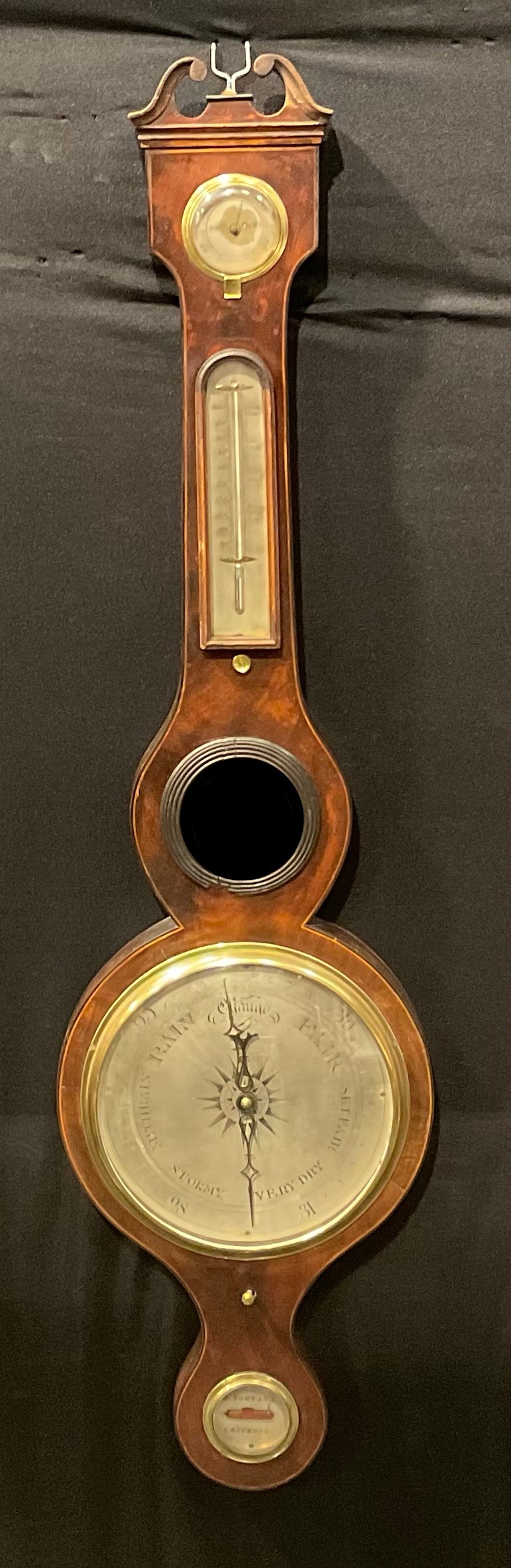 A 19th century mahogany wheel barometer, 20cm silvered register, hygrometer, mercury thermometer,
