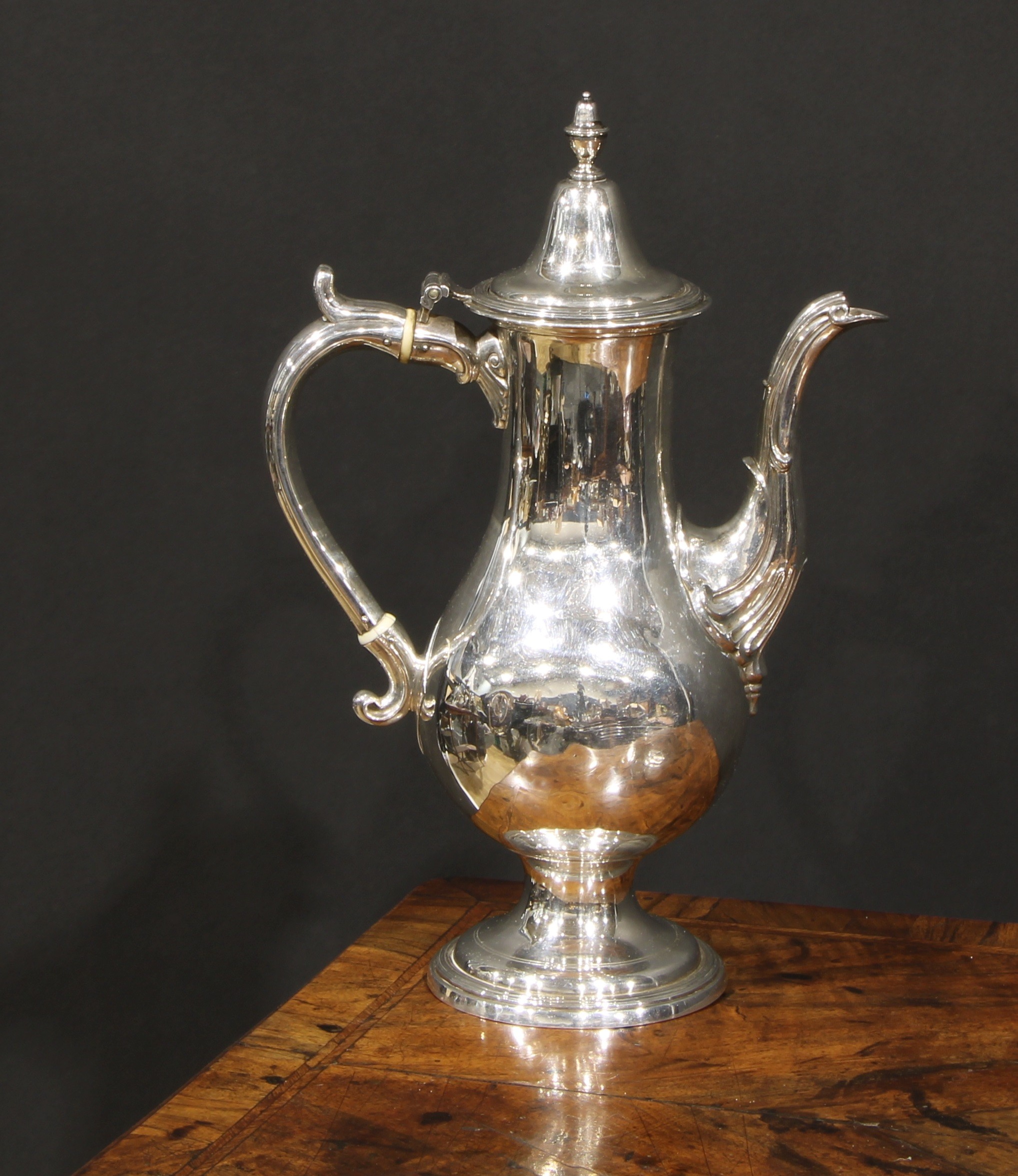 A George III Provincial silver baluster coffee pot, hinged cover with acorn finial, scroll handle,