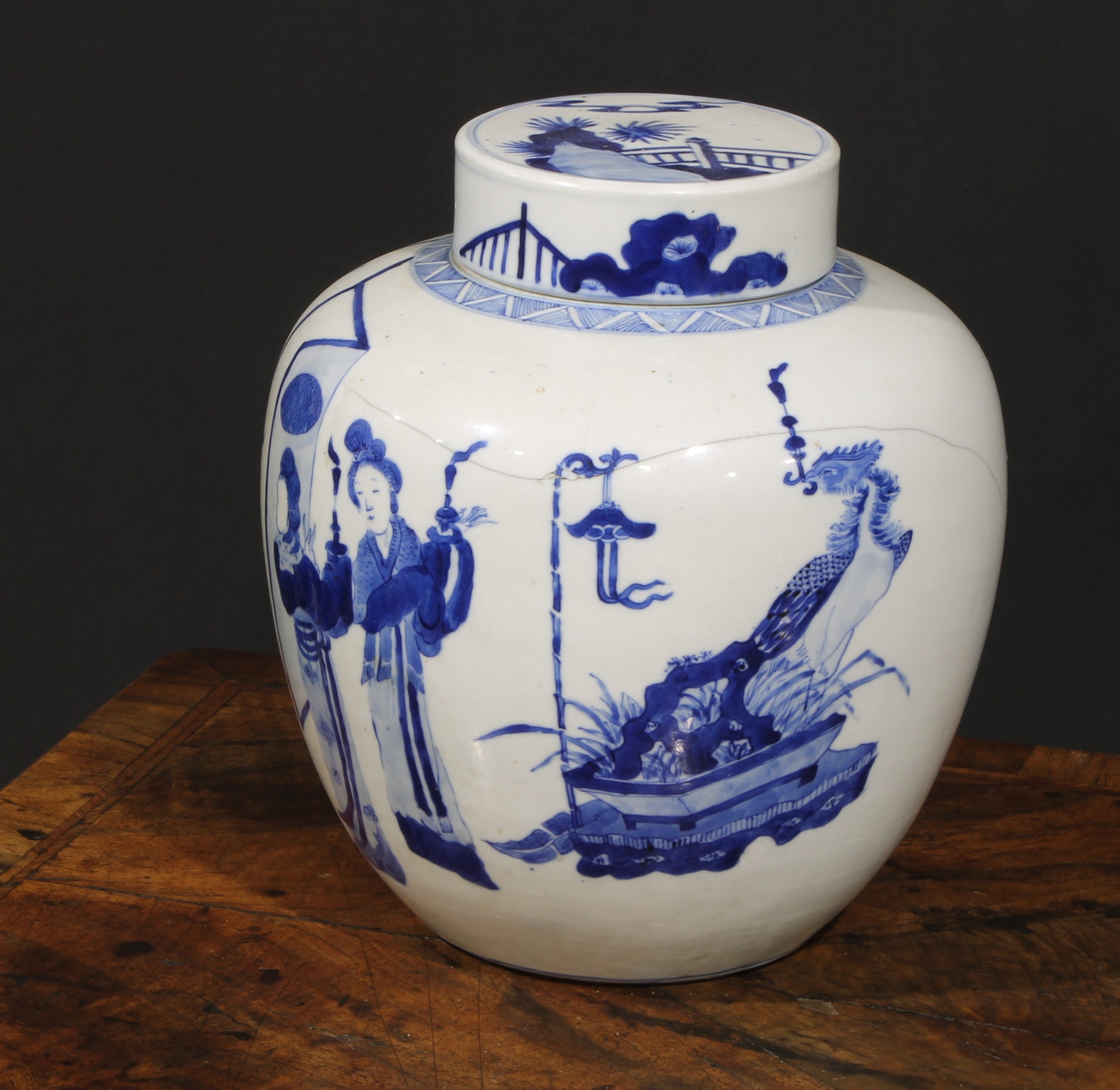 A Chinese ovoid ginger jar and cover, painted in tones of underglaze blue with ladies of the