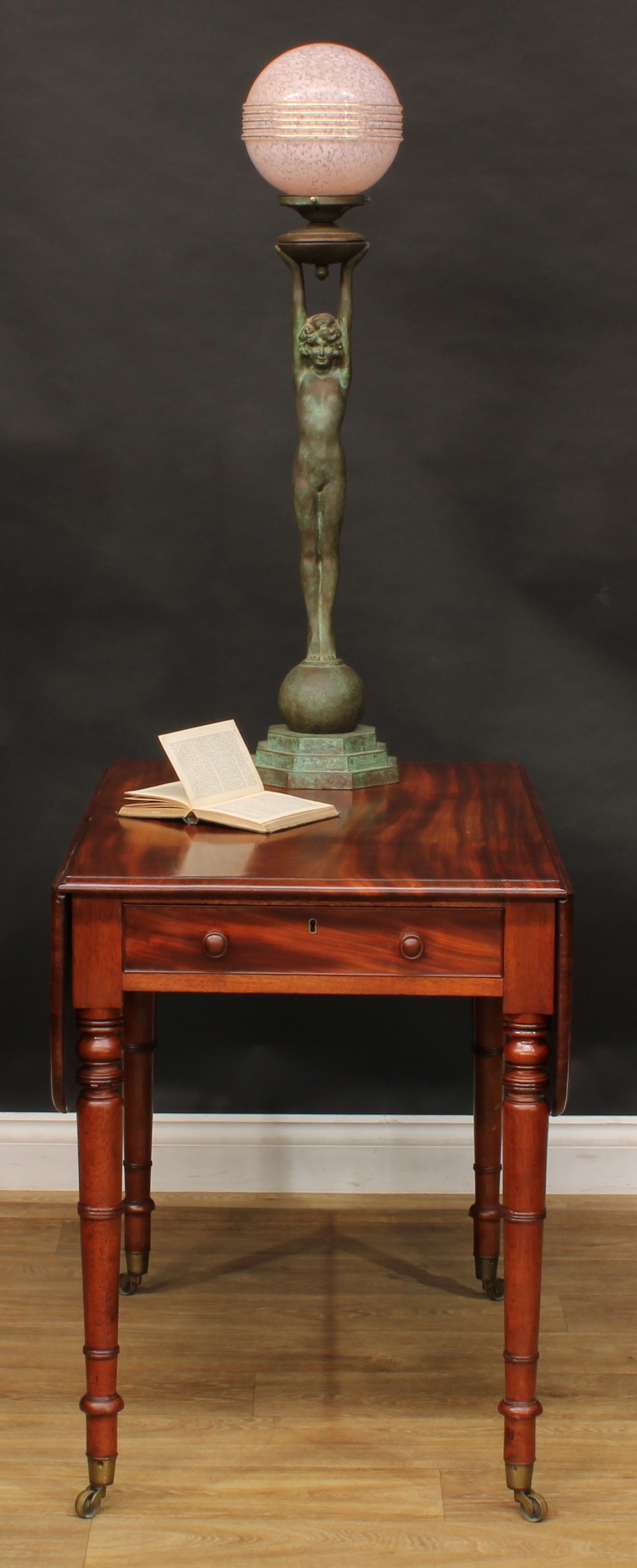 A George IV mahogany Pembroke table, rounded rectangular top with fall leaves above a single