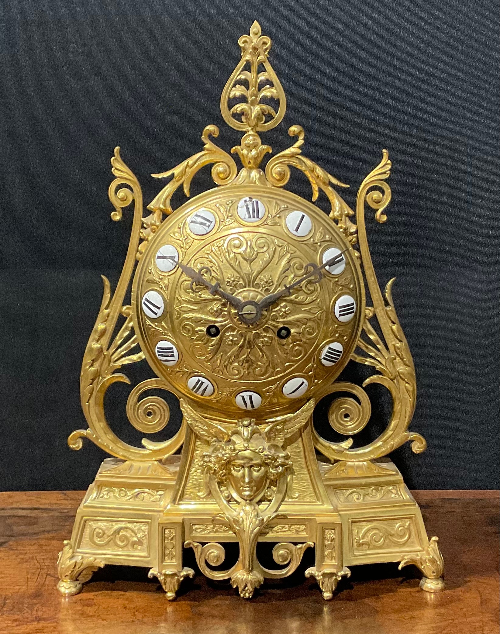 A 19th century Etruscan Revival ormolu mantel clock, the 14cm dial applied with enamel Roman numeral