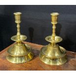 A pair of 19th century brass candlesticks, possibly Spanish, broad drip pan, trumpet shaped base,