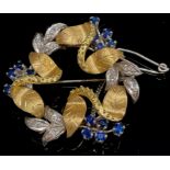 An 18ct white and yellow gold wreath brooch, formed from intertwined flowering stems and leaves, the