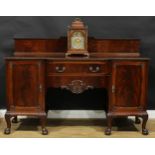 A George II Revival mahogany serving table or sideboard, in the Irish taste, the back centred by a