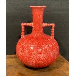 A Burmantofts Faience two handled globular vase, elongated neck, flared frilled rim, angular rope