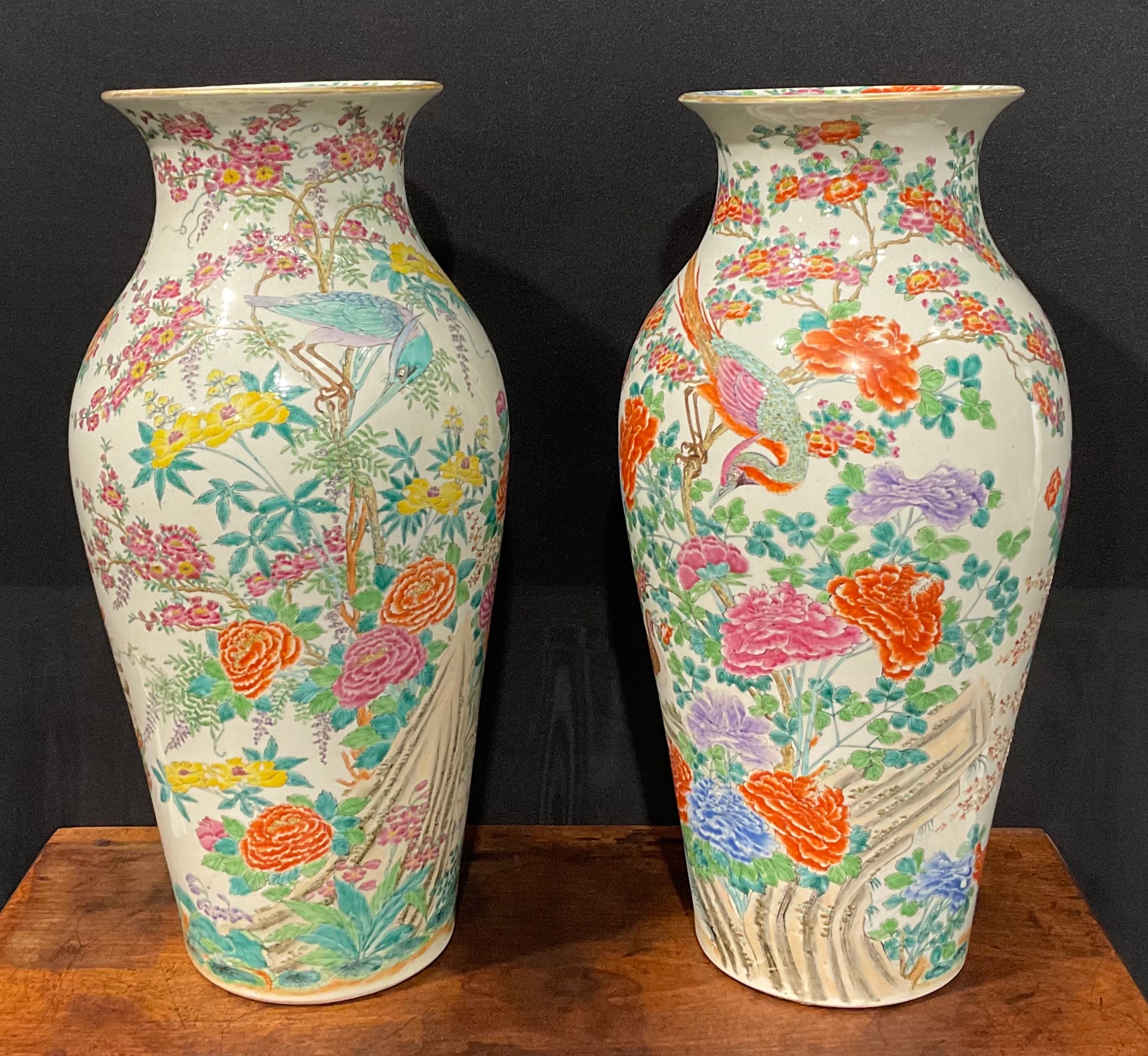 A pair of large Japanese inverted baluster vases, decorated in the Chinese manner with exotic