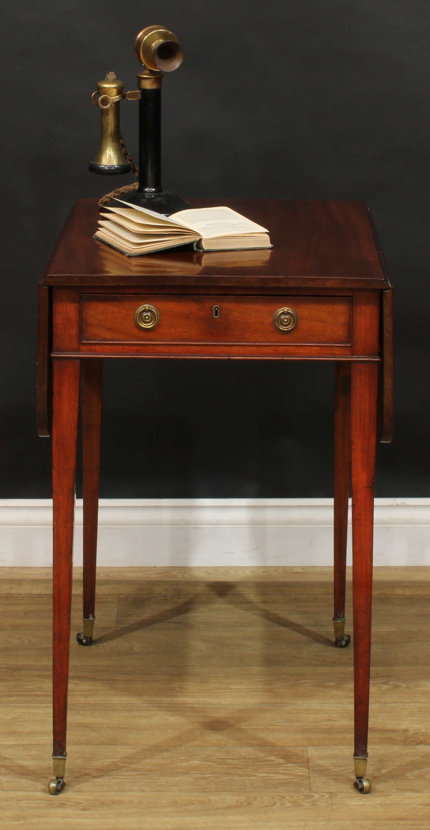 A George III mahogany Pembroke table, of small and neat proportions, rounded rectangular top with