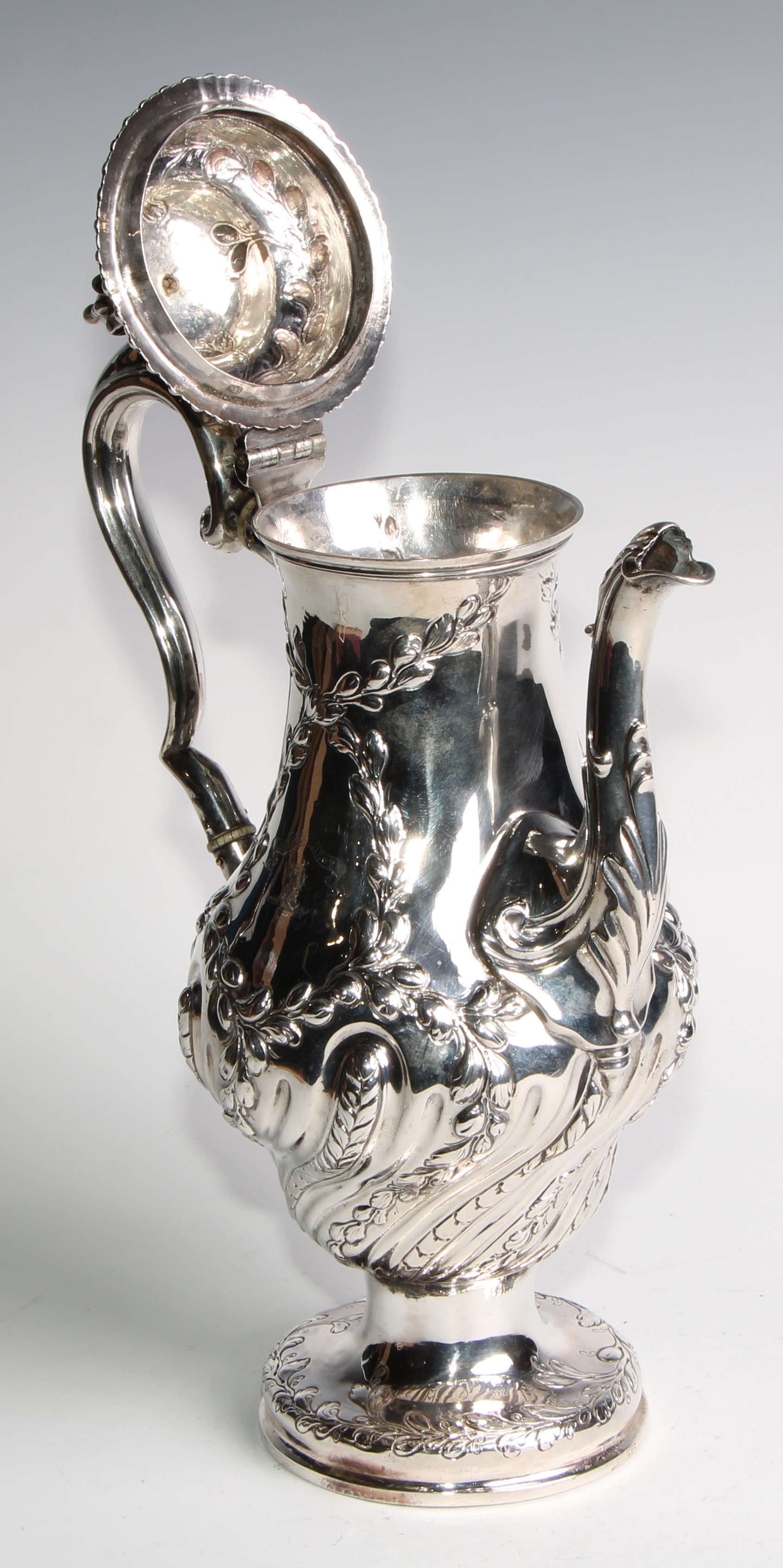 An early George III silver baluster coffee pot, wrythen half-fluted and chased with leafy - Image 4 of 6