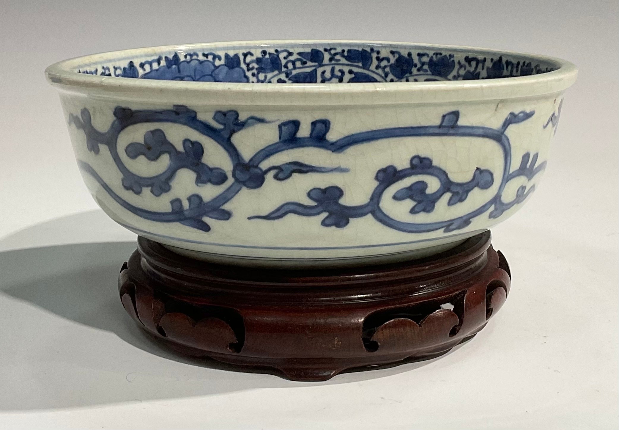 A Chinese circular bowl, painted in tones of underglaze blue with prunus, chrysanthemums and - Image 3 of 5