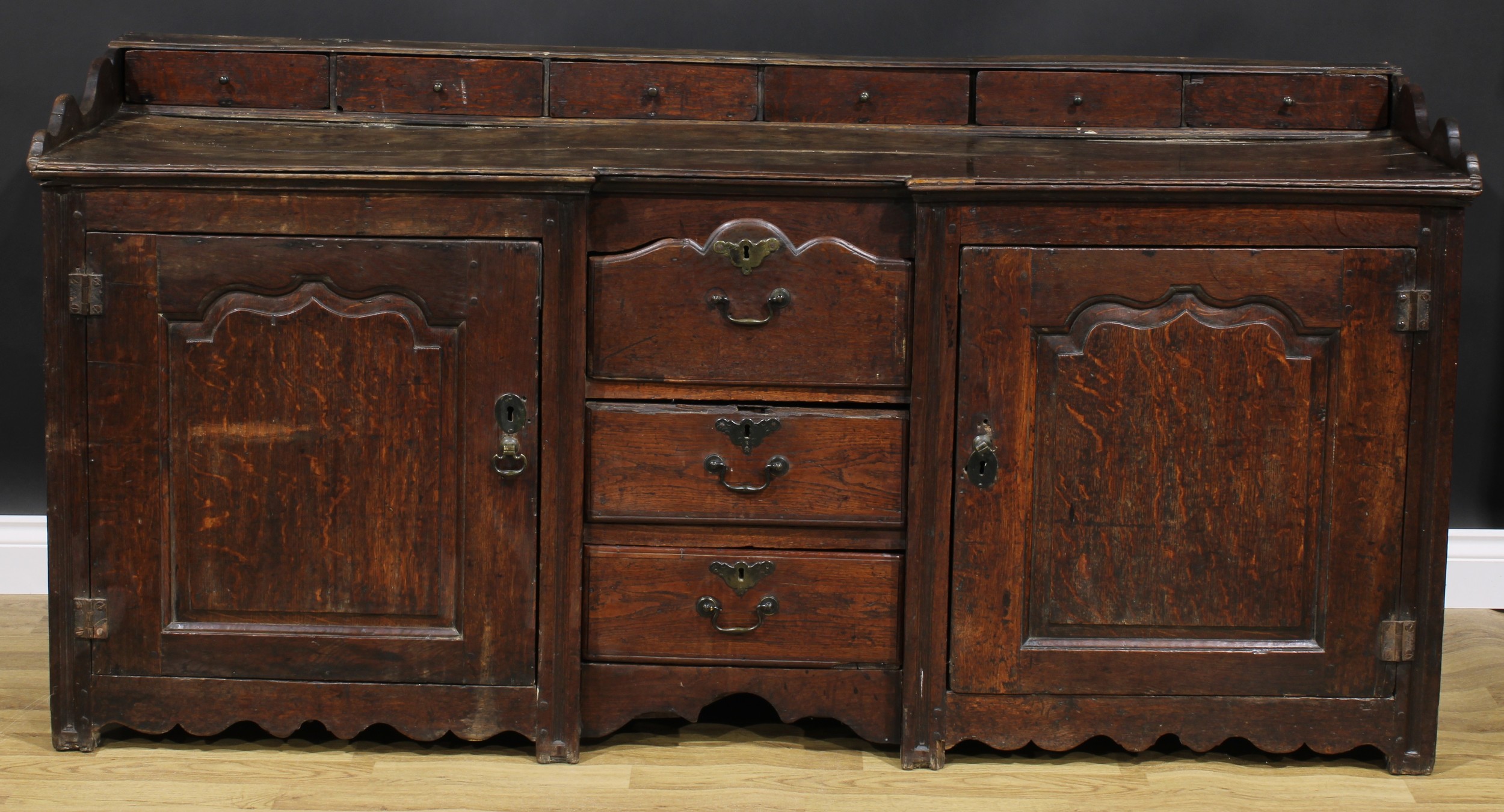 An 18th century oak low dresser, rectangular top with six small drawers above a pair of raised and - Image 2 of 6