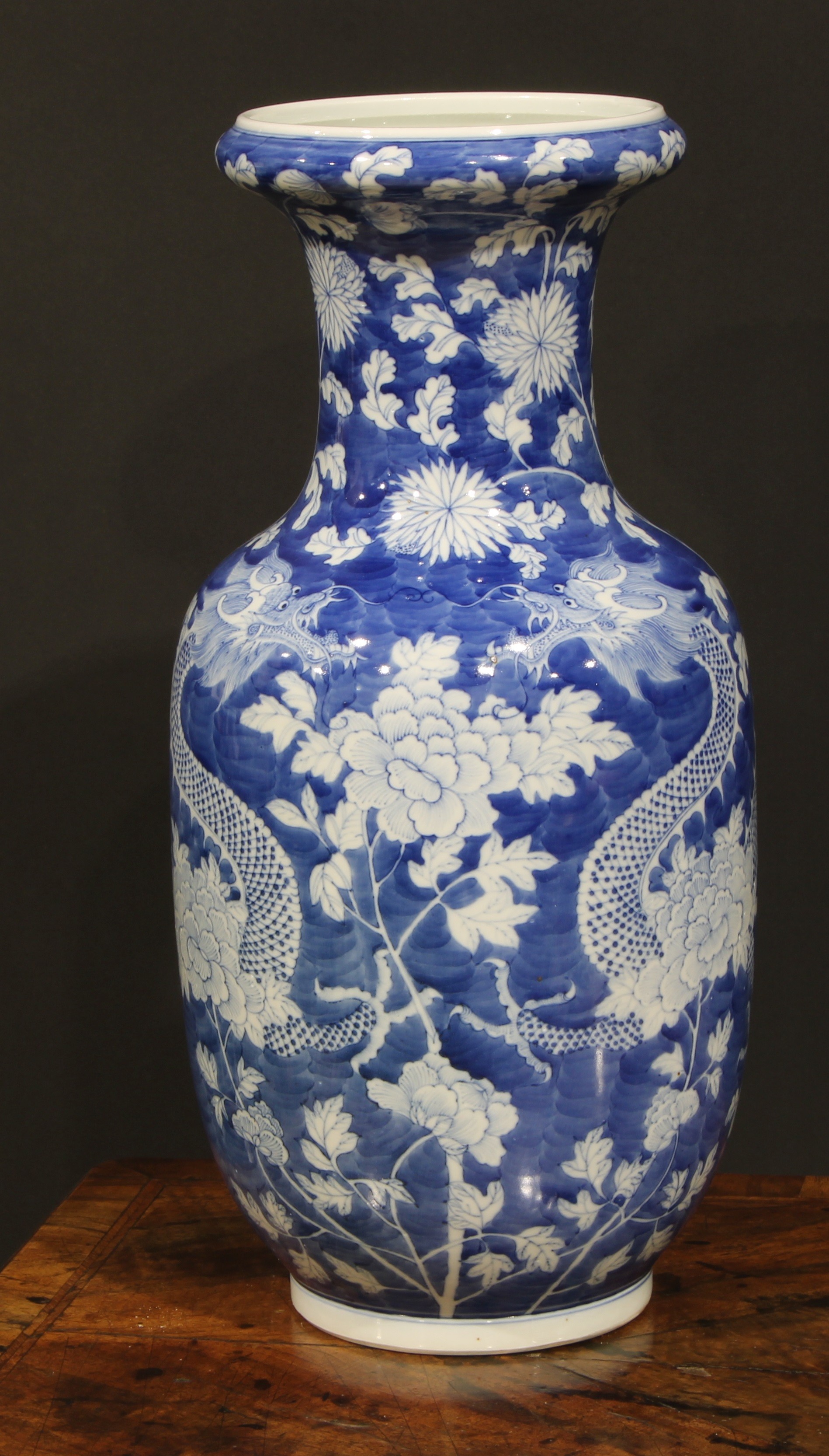 A large Chinese ovoid vase, painted in tones of underglaze blue with dragons amongst flowers and