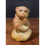 A Burmantofts Faience model, of a seated robed monkey, glazed in mottled tones of bronze lustre,