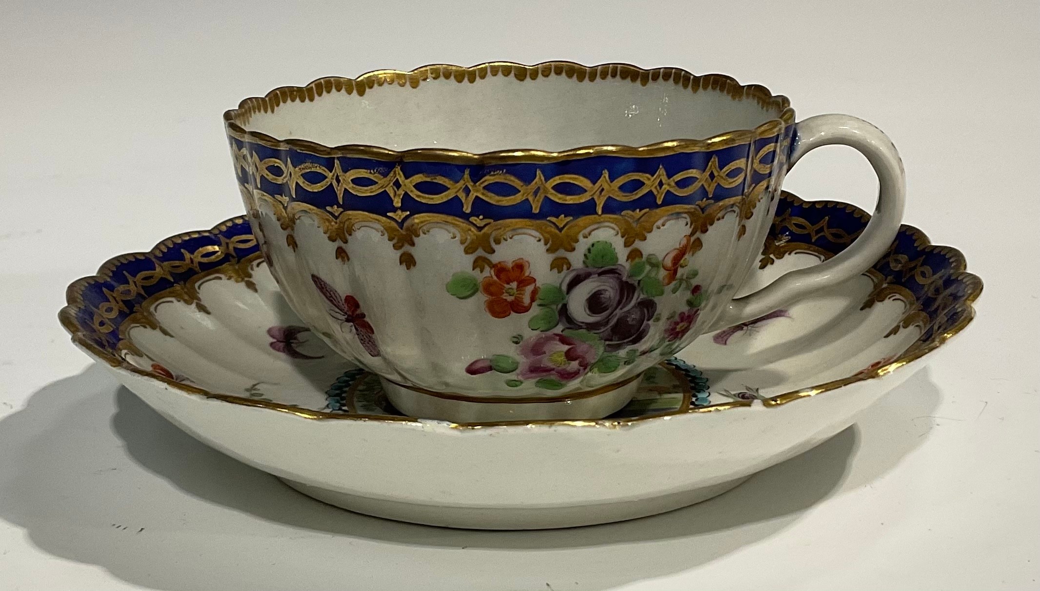 A Worcester fluted teacup and saucer, circular cartouches painted with lakeside scenes, edged with a - Image 3 of 11