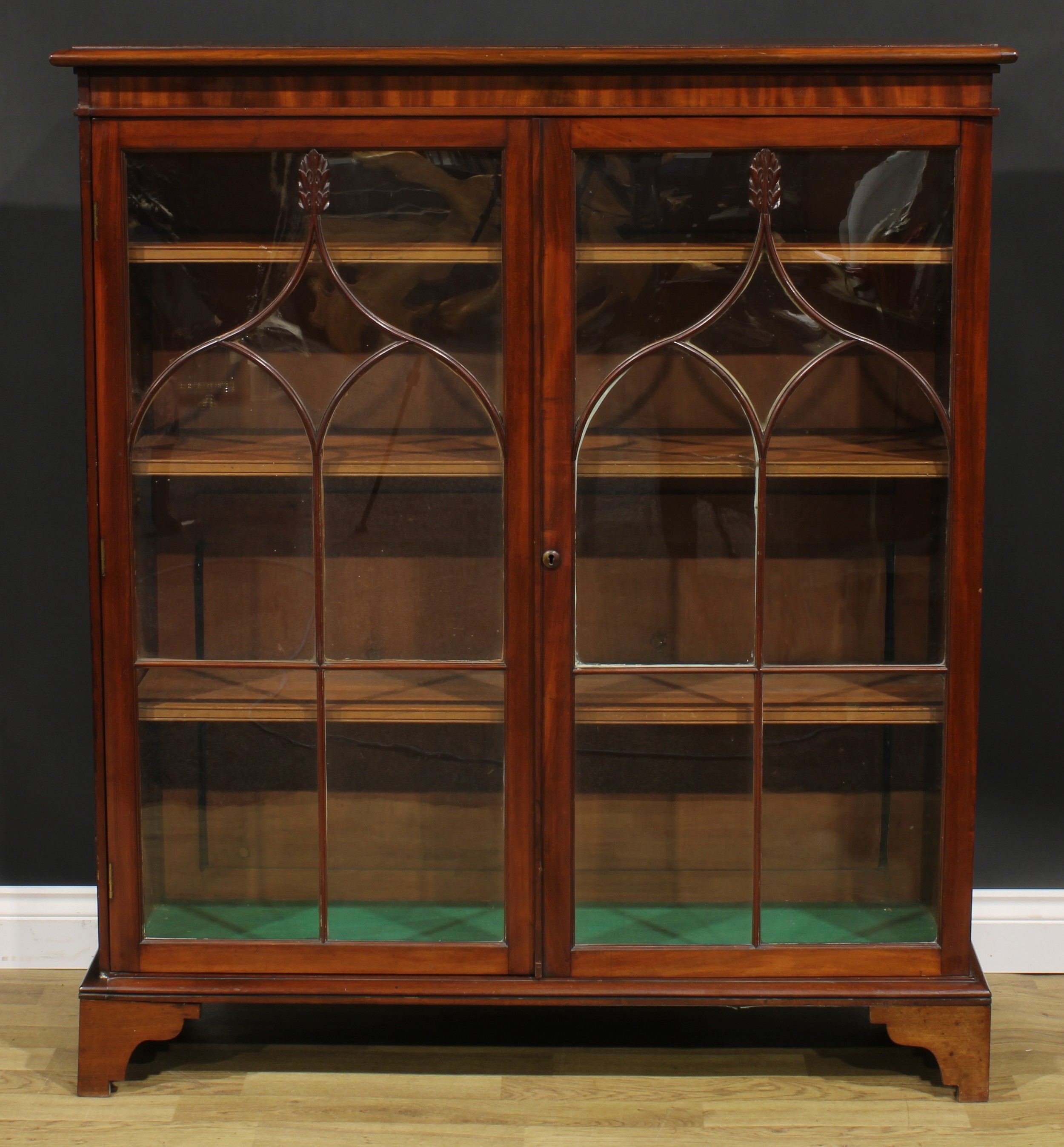 A 19th century mahogany low library bookcase, oversailing top above a pair of glazed doors enclosing - Image 2 of 5