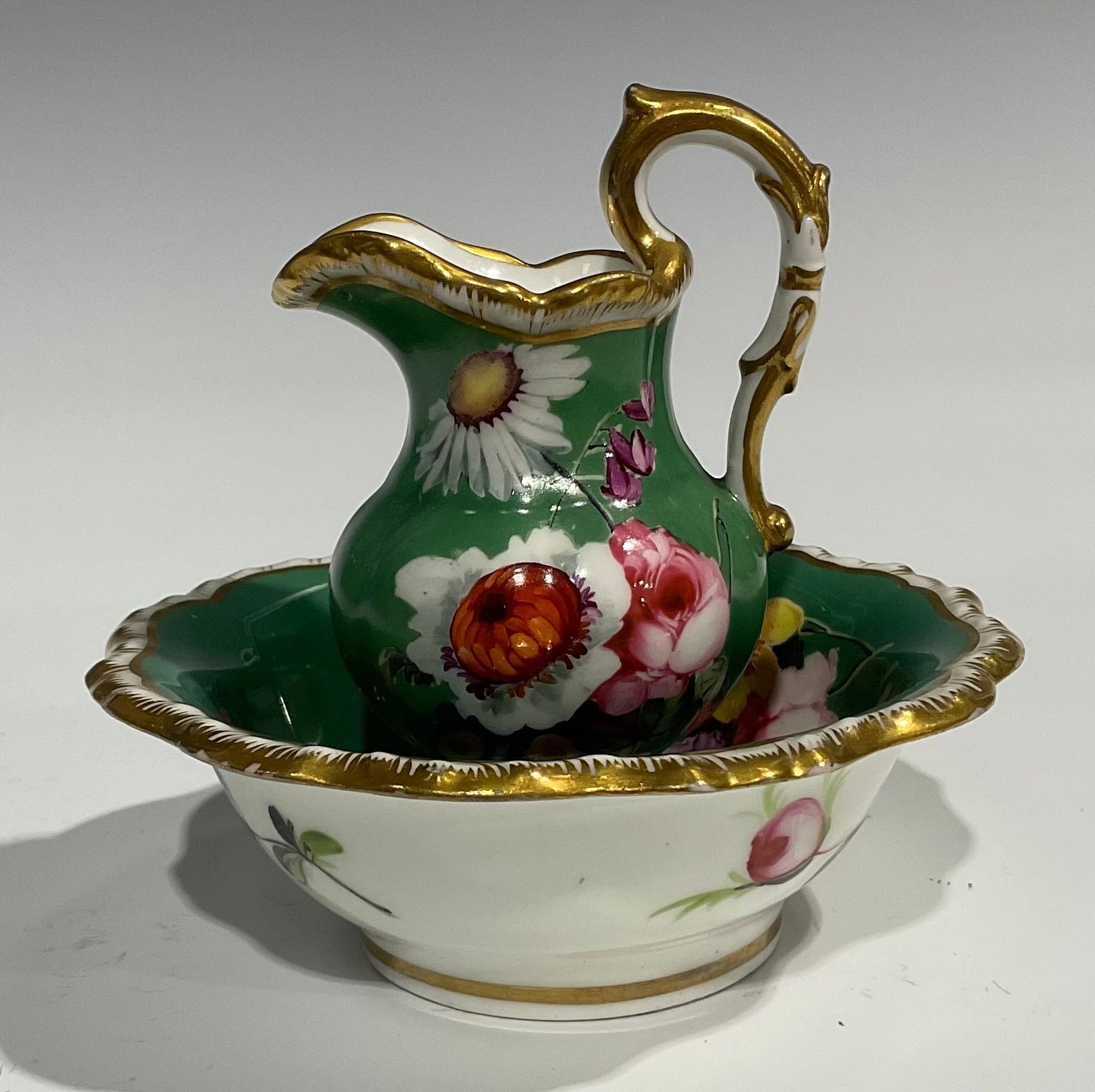 An English porcelain miniature jug and bowl, probably Rockingham, painted with flowers on a green - Image 3 of 12