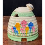 A Clarice Cliff Spring Crocus pattern ribbed domed honey pot and cover, the cover with bee knop,