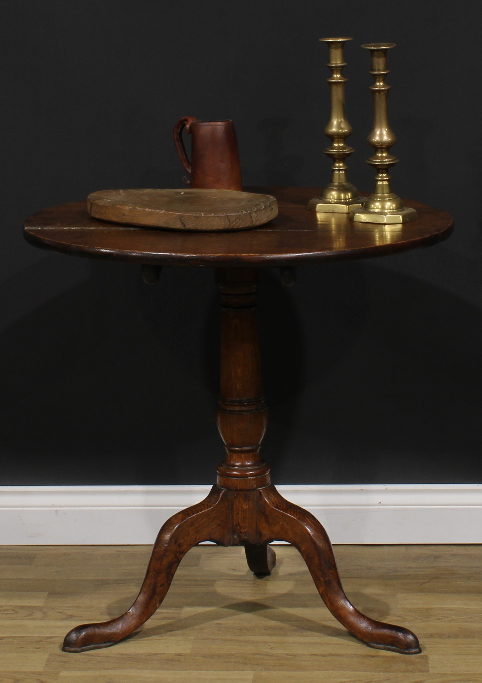 A George III oak tripod occasional table, circular tilting top, cannon barrel column, cabriole legs,
