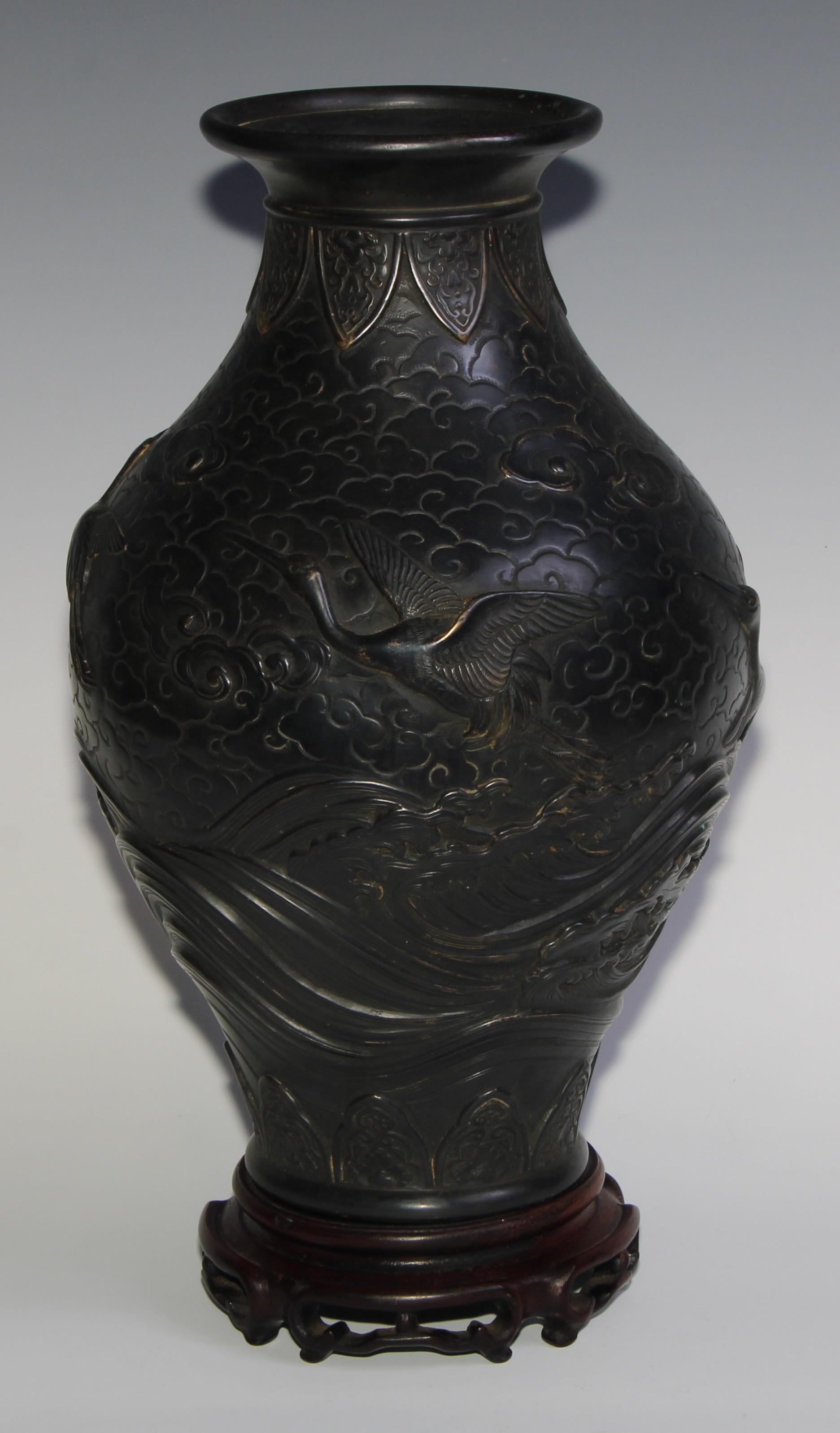 A Japanese dark patinated bronze ovoid vase, cast in relief with cranes taking flight amongst - Image 2 of 7