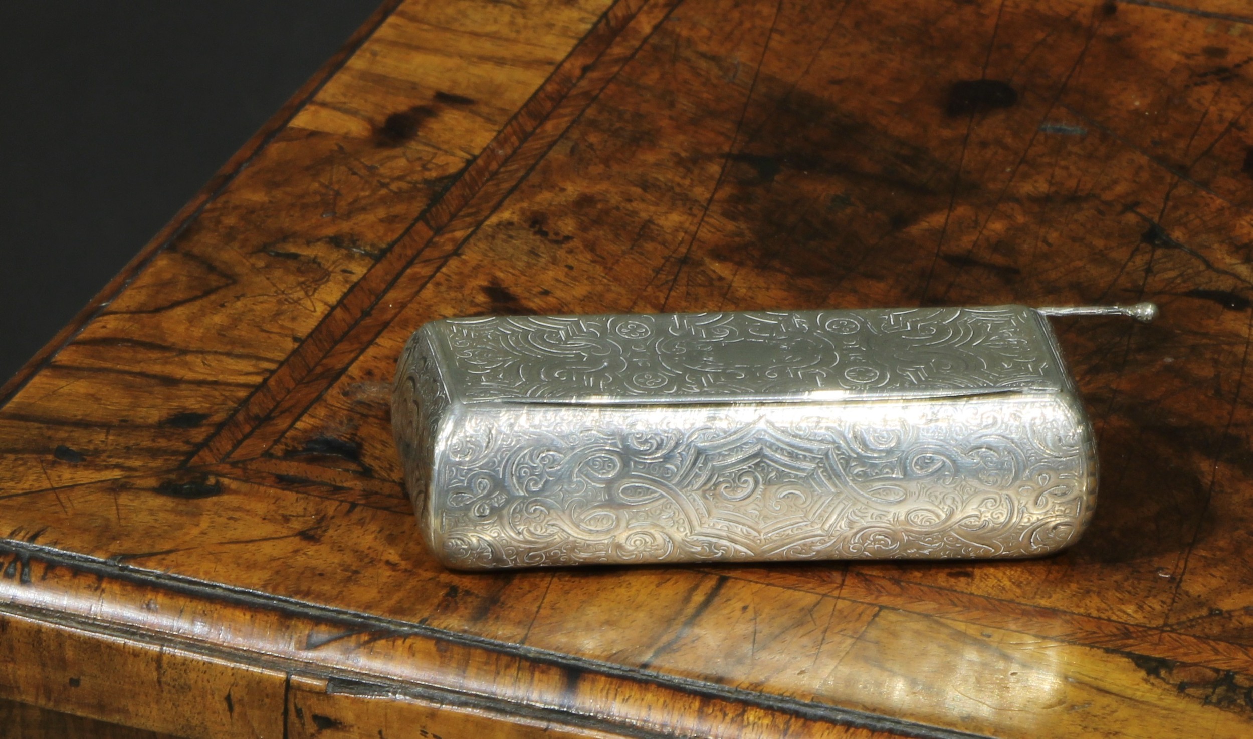 A 19th century French bowed rectangular snuff box, engraved and chased overall with strap work and