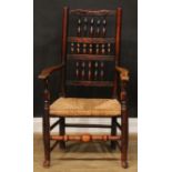 A 19th century fruitwood and elm spindleback elbow chair, rush seat, turned fore stretcher, 105cm