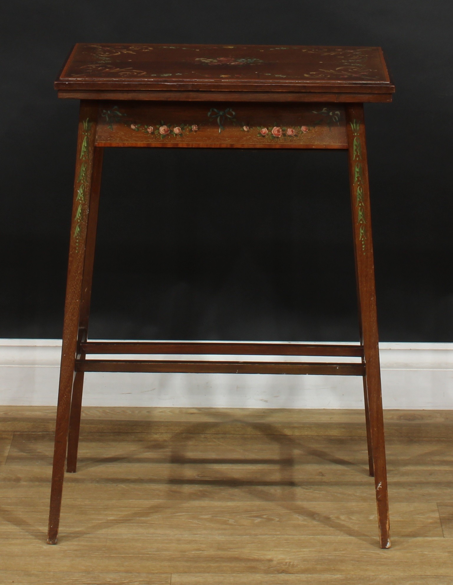 A Sheraton Revival satinwood crossbanded and painted mahogany card table, hinged top enclosing a