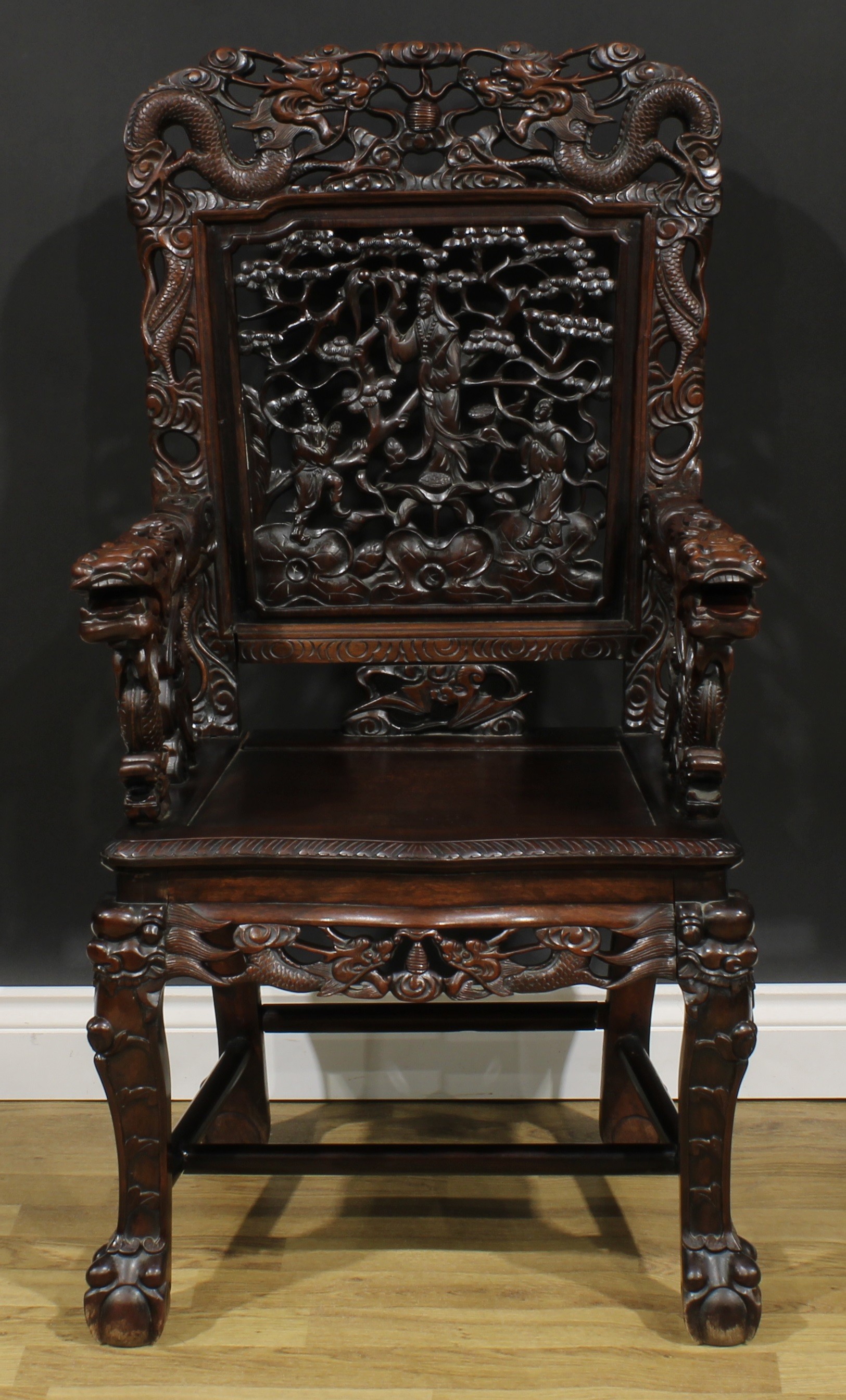 A Chinese hardwood armchair, shaped cresting rail pierced and carved with two dragons and a