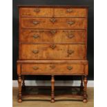 A ‘Queen Anne’ featherbanded walnut chest on stand, oversailing rectangular top above two short