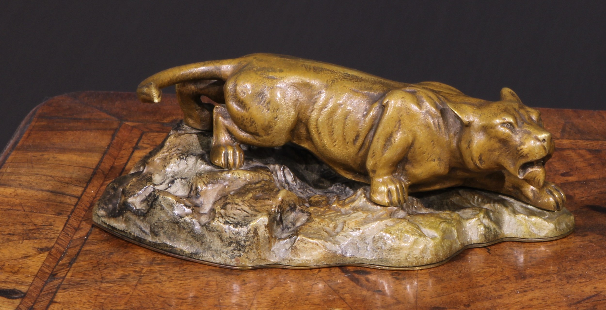 Continental School (early 20th century), a patinated bronze, of a mountain lion, stalking a rocky