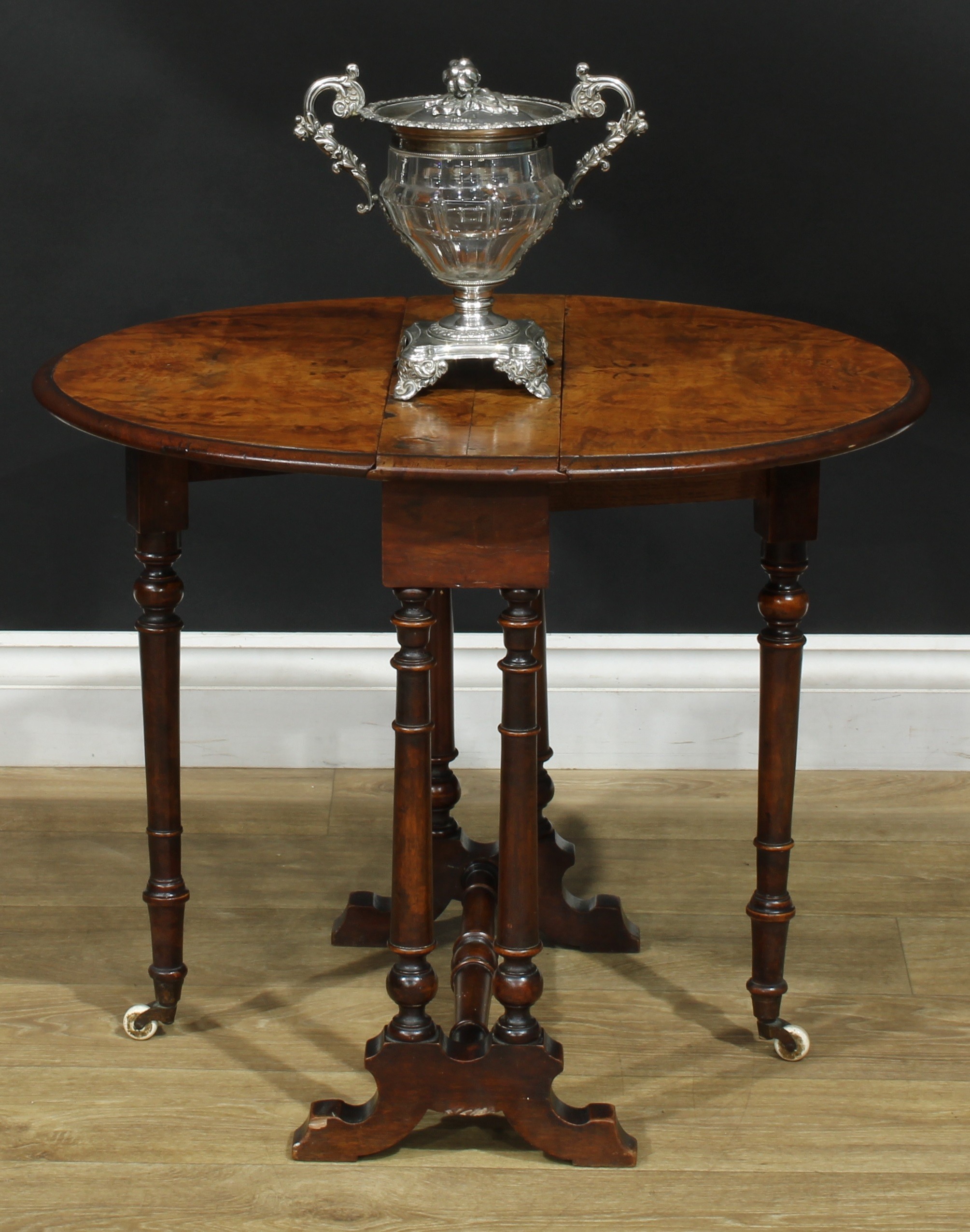 A Victorian walnut Sutherland table, of small proportions, oval top with fall leaves, turned