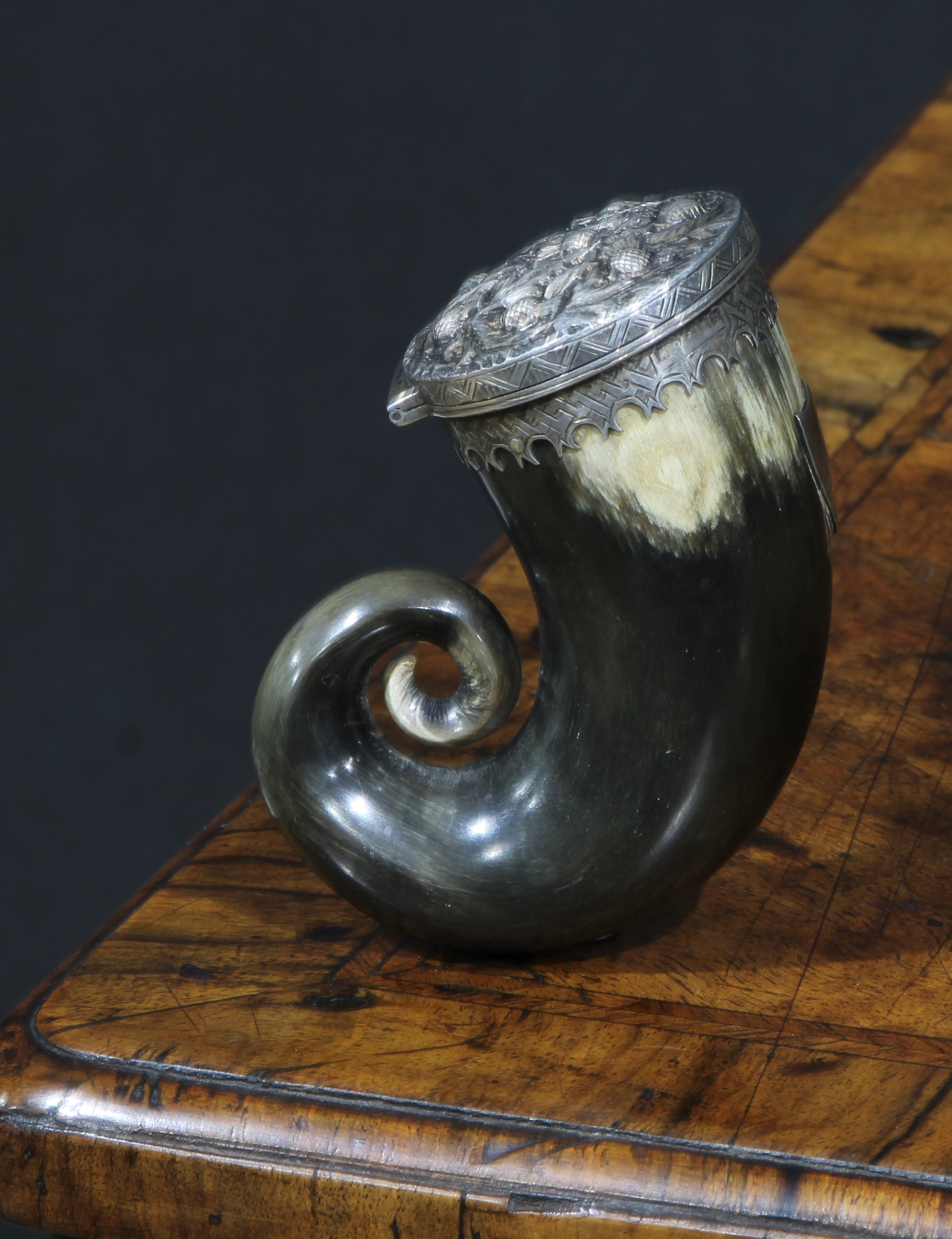 A Scottish silver mounted horn snuff mull, the hinged cover chased with thistles, shaped pendant