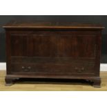 A George III oak mule chest, hinged two panel top, above a long drawer, skirted base, ogee bracket