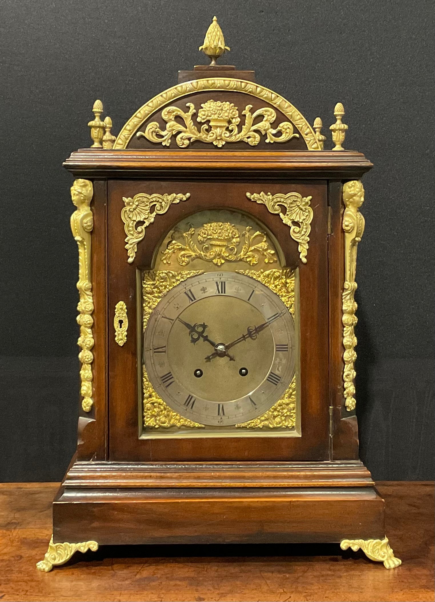 A George II style gilt metal mounted mahogany bracket clock, 18.5cm arched brass dial with
