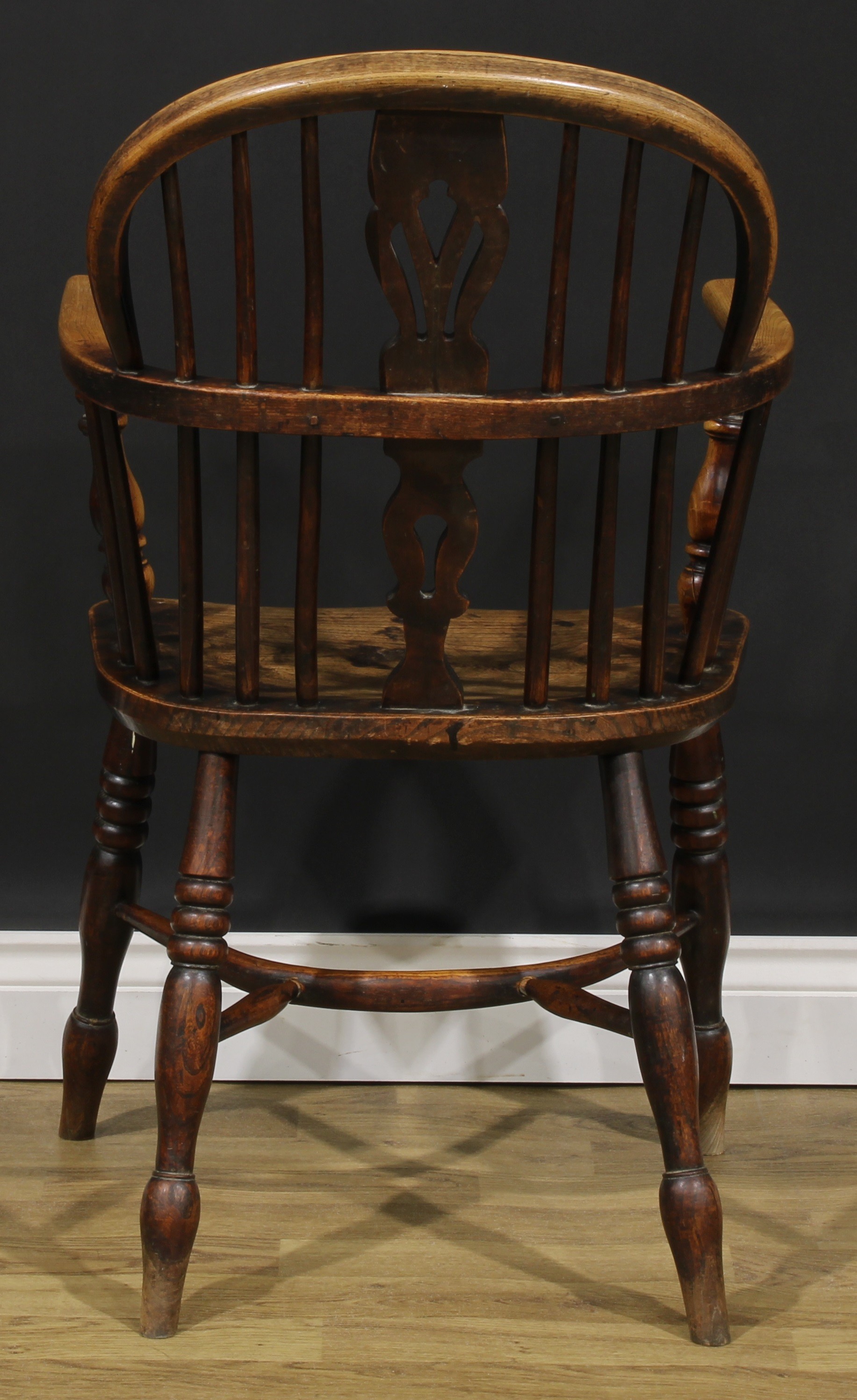 A 19th century East Midlands ash and elm Windsor elbow chair, low hoop back, shaped and pierced - Image 4 of 4