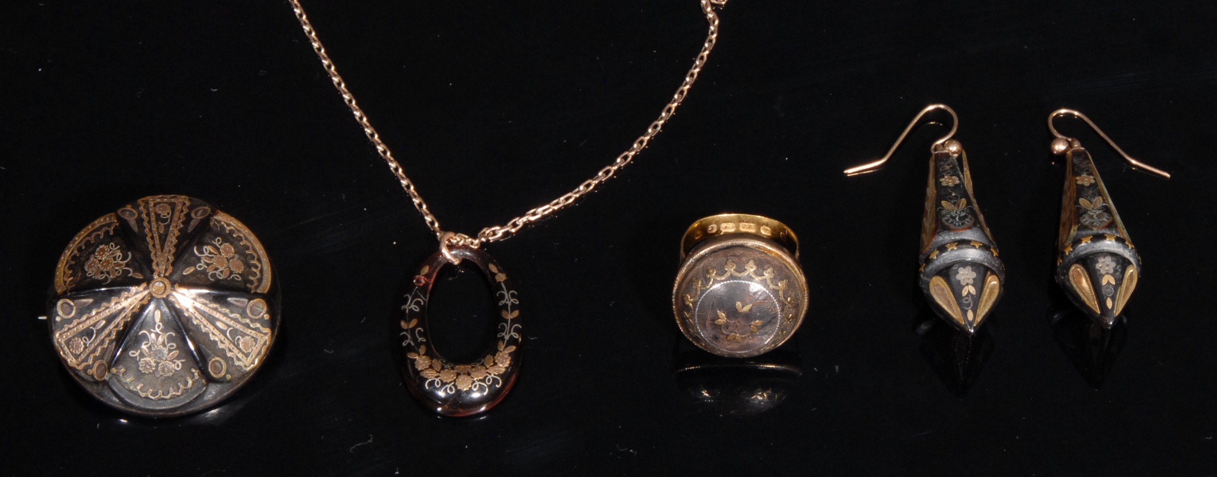 A composed suite of 19th century tortoise shell gold inlaid jewellery, comprising a 22ct gold