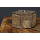 A George III rolled paper quill work lozenge shaped tea caddy, hinged cover with brass axehead