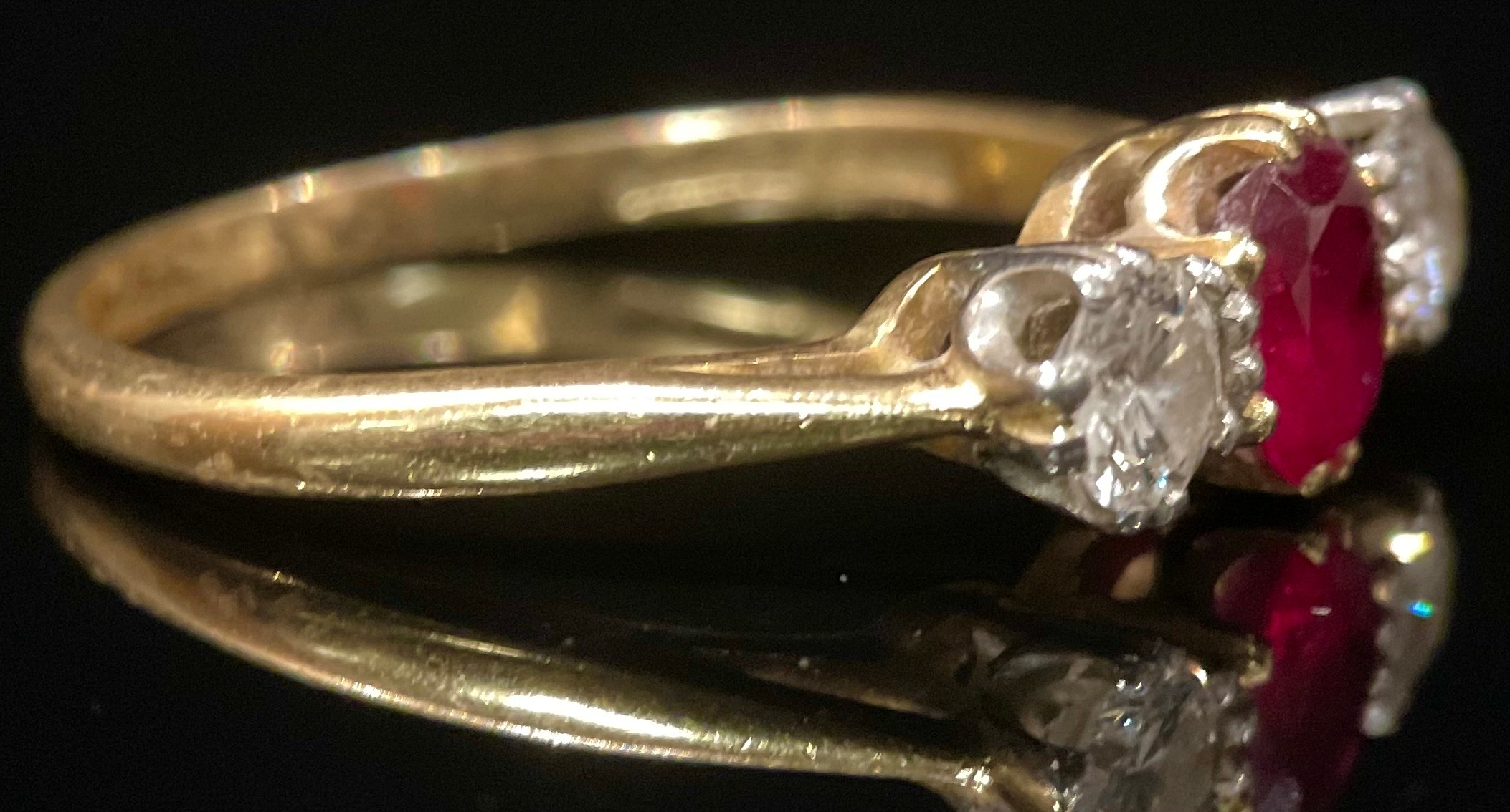 A diamond, rub and 18ct gold three stone ring, the central ruby flanked by a pair of round brilliant - Image 2 of 3