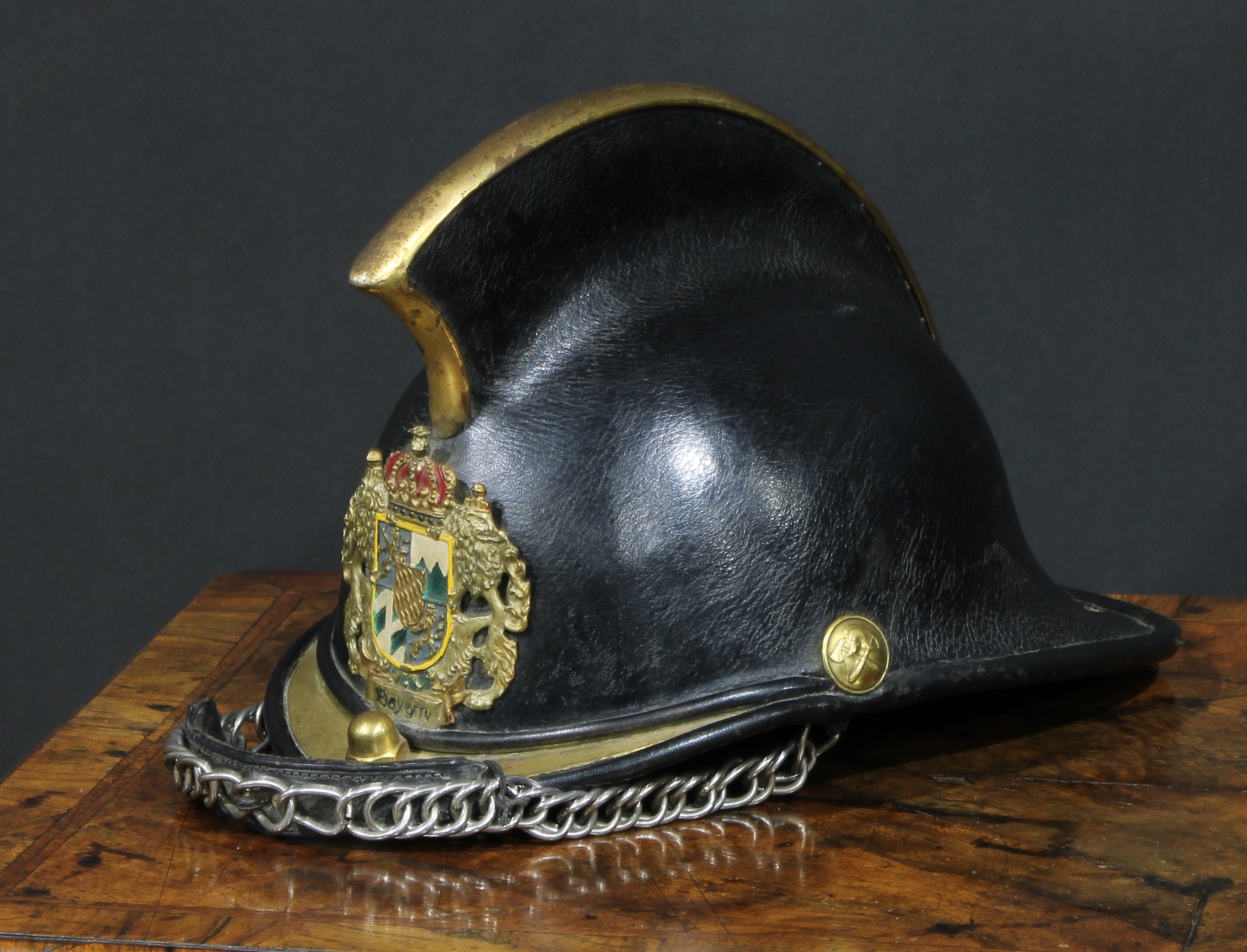 Fire Brigade History - a leather and brass fireman's helmet, applied with the German arms of Bayern,