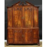 A 19th century Dutch mahogany enclosed library cabinet, broken-arch pediment above a pair of panel