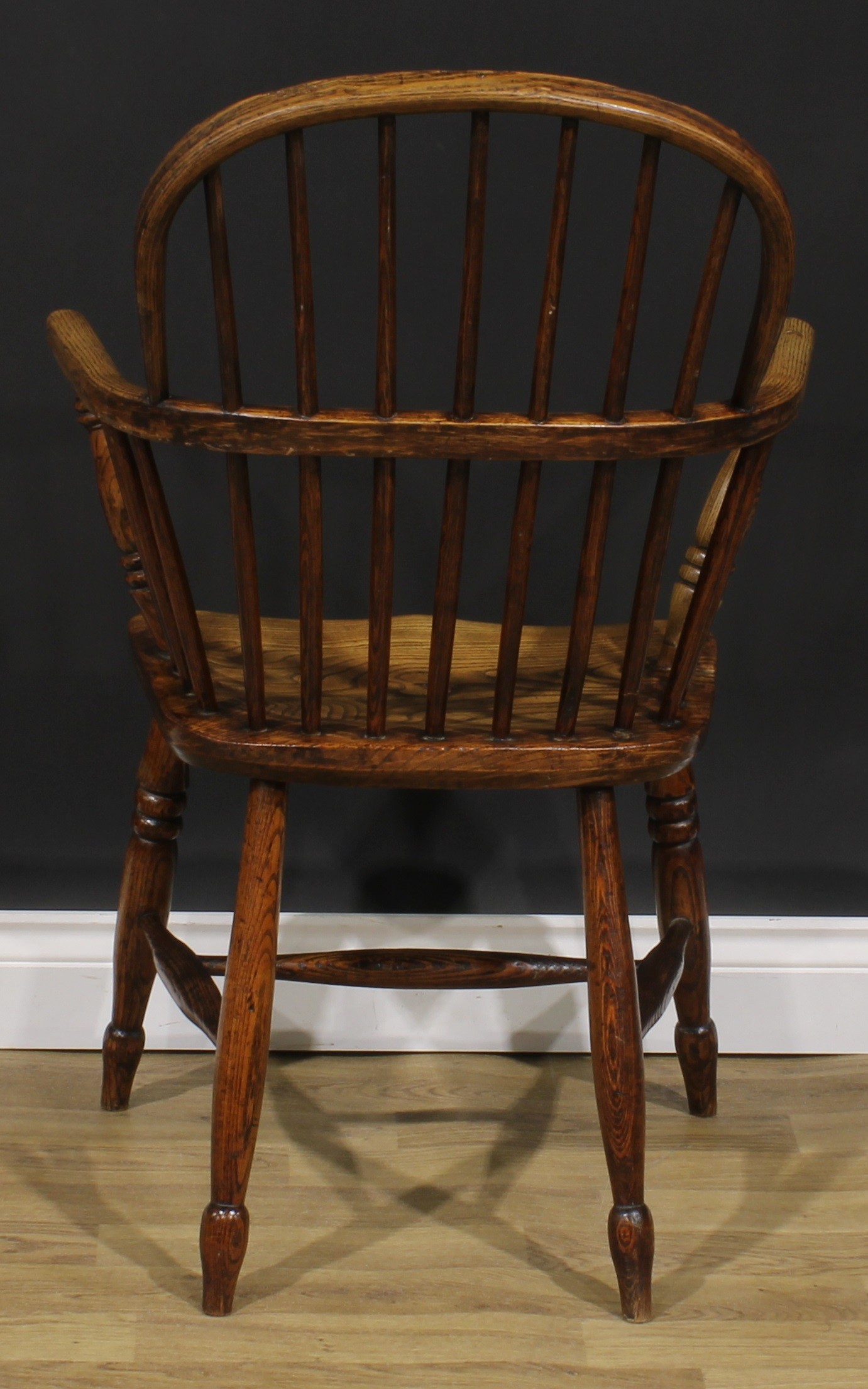 A 19th century ash and elm Windsor elbow chair, low hoop back, saddle seat, H-stretcher, 95cm - Image 4 of 4