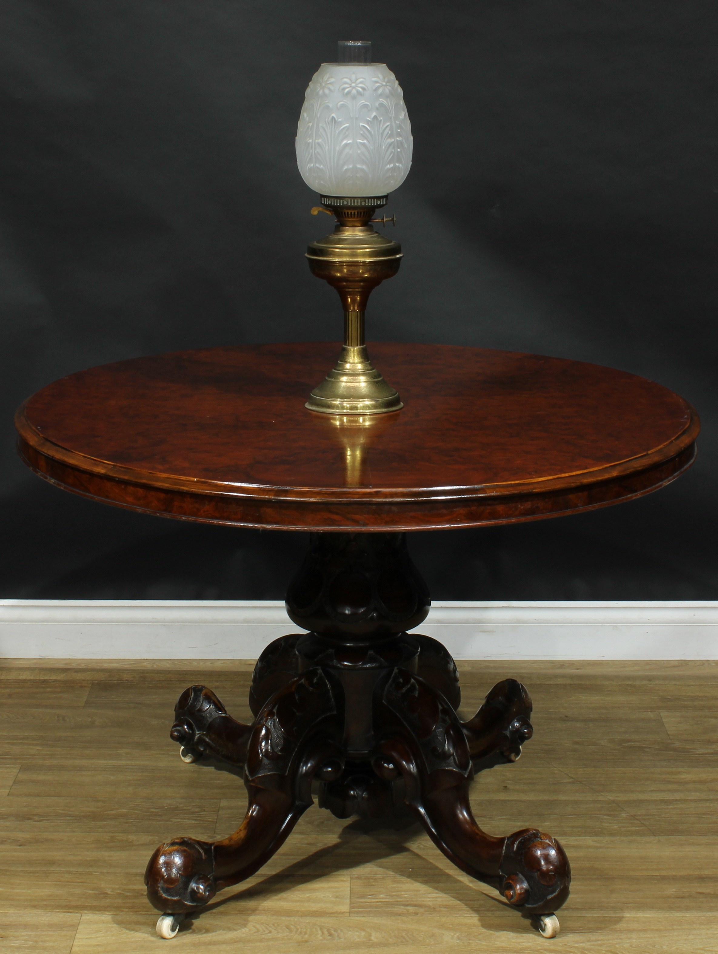 A Victorian walnut centre table, oval tilting top, turned column, cabriole legs, ceramic casters,