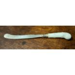 A rare Worcester Blanc de Chine knife handle, pistol grip, moulded with scrolls, the steel blade