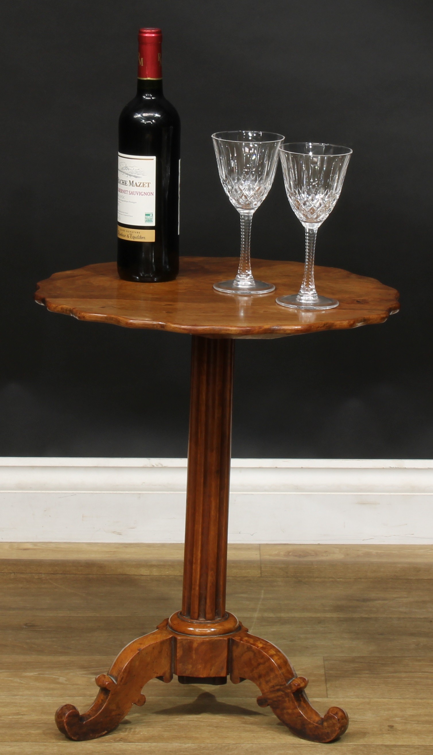 A 19th century walnut and satin birch tripod wine table, shaped circular top, fluted column,
