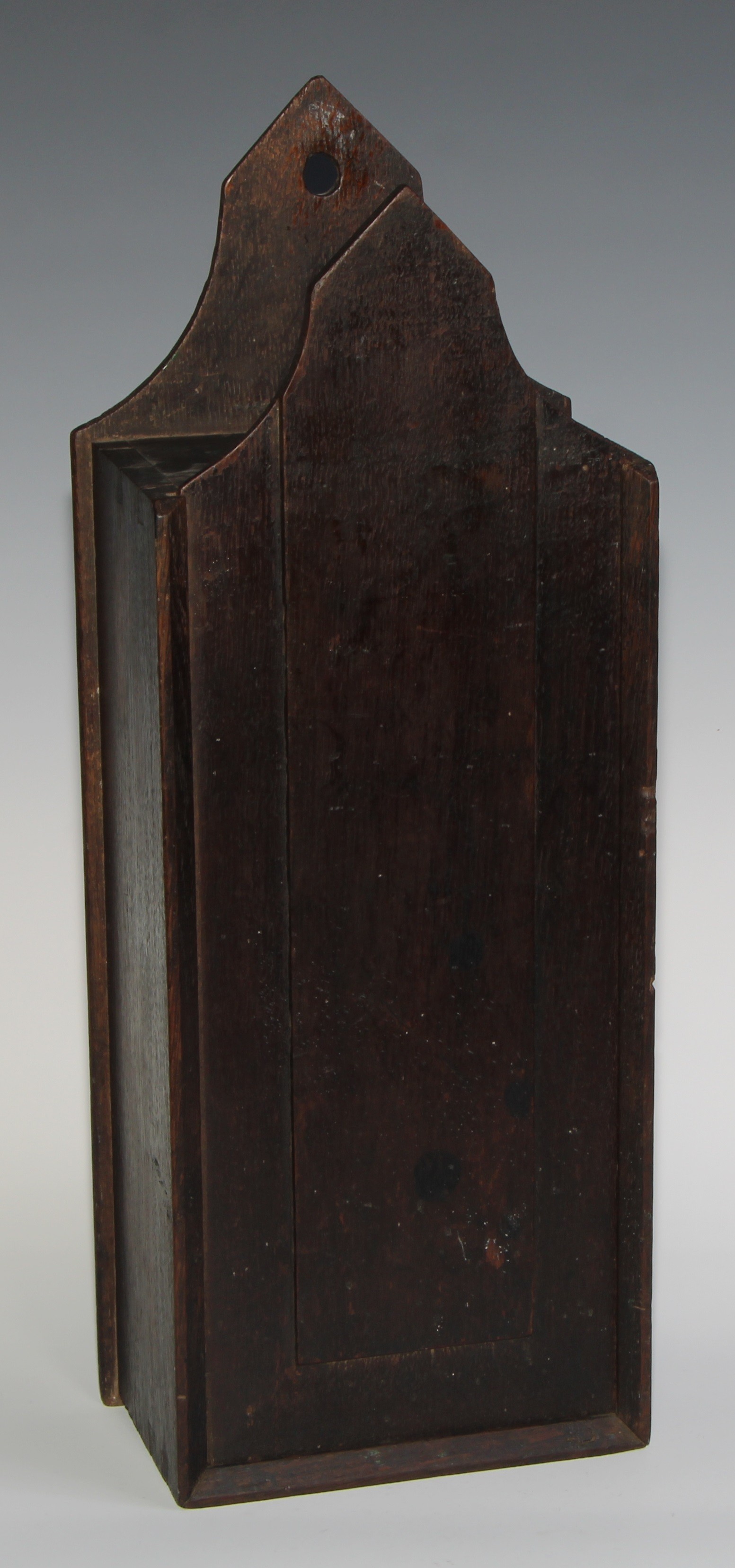 A George III oak candle box, possibly Welsh, pointed arched cresting, raised panelled sliding cover, - Image 2 of 4