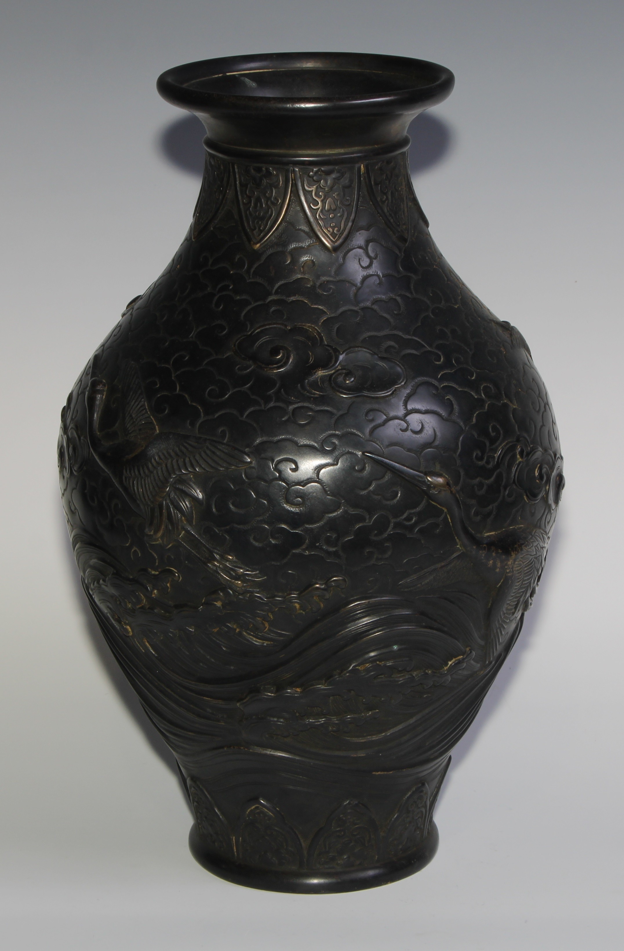 A Japanese dark patinated bronze ovoid vase, cast in relief with cranes taking flight amongst - Image 3 of 7