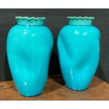 A pair of Burmantofts Faience dimpled ovoid vases, flared frilled rims, glazed throughout in