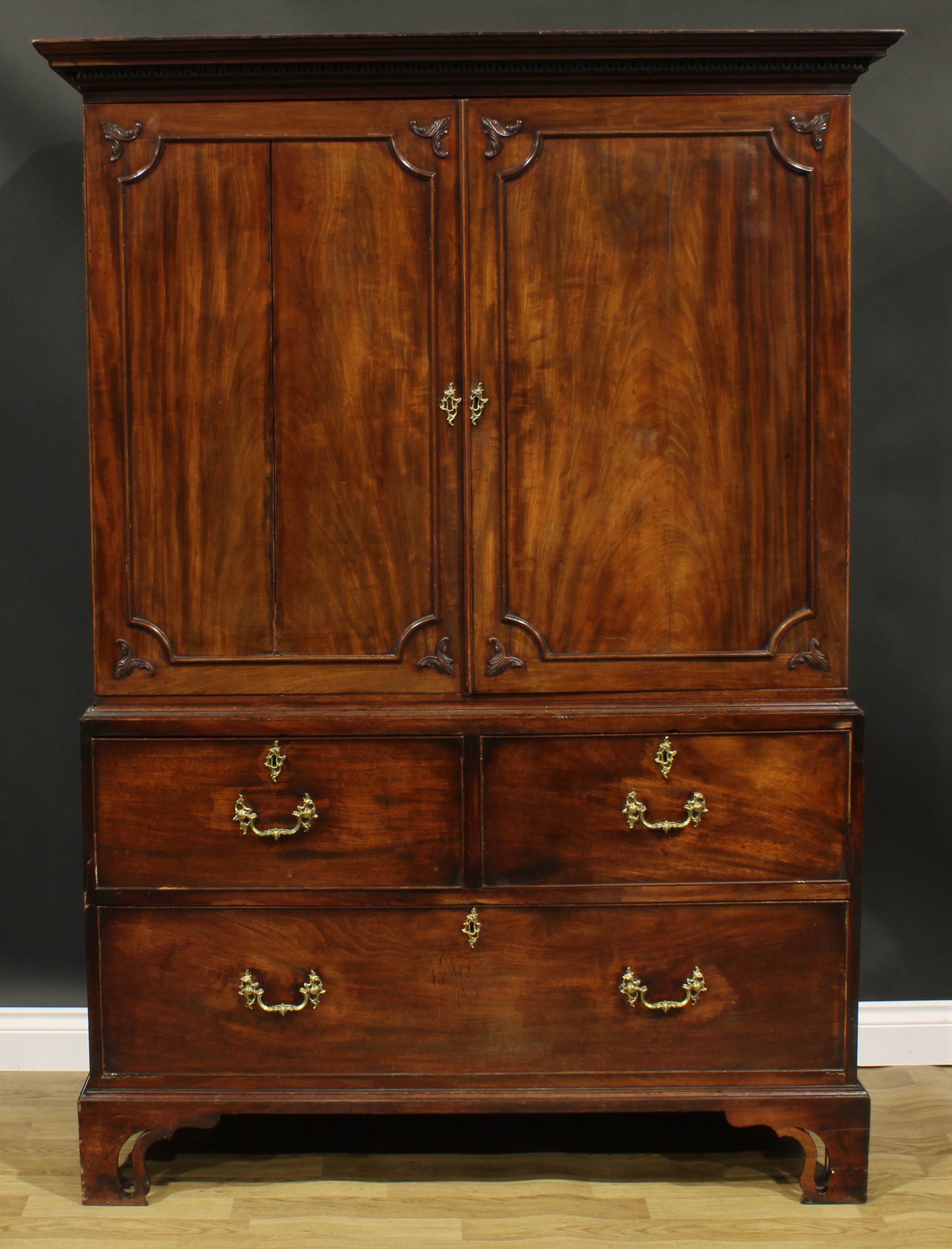 A 19th century mahogany linen press, outswept cornice with meandrous capital above a pair of panel