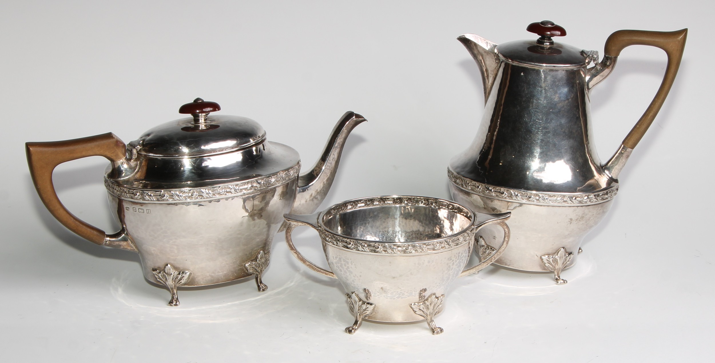 An Arts and Crafts silver three piece tea service, comprising teapot, hot water pot and sugar basin, - Image 2 of 15