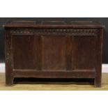 A 17th century oak blanket chest, hinged top, nulled frieze, three panel front, 74cm high, 115cm