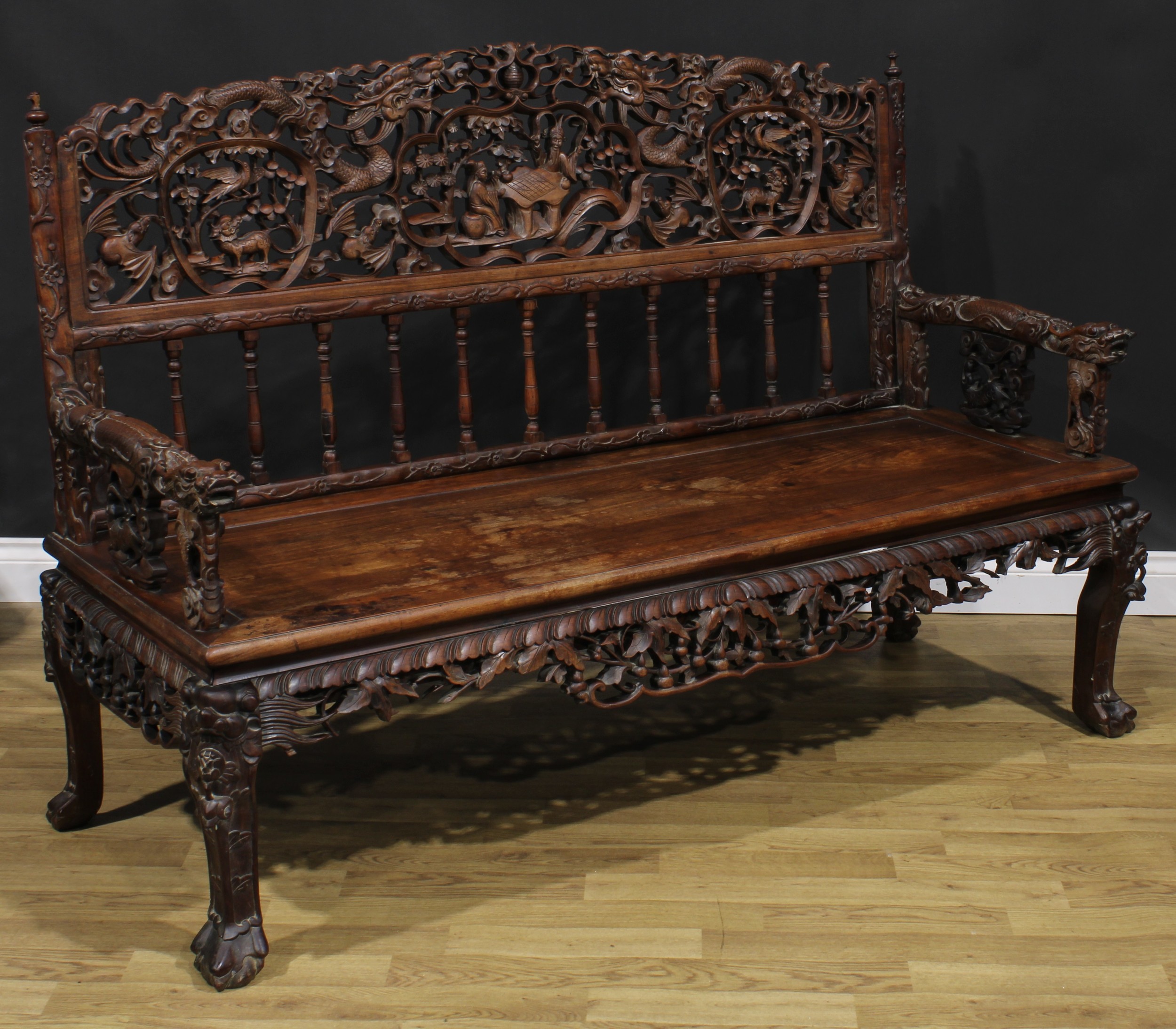 A Chinese hardwood bench or settle, arched cresting pierced and profusely carved with dragons, - Image 2 of 4